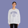 Person wearing a gray sweatshirt with 'AMOR' and a heart design on a white background