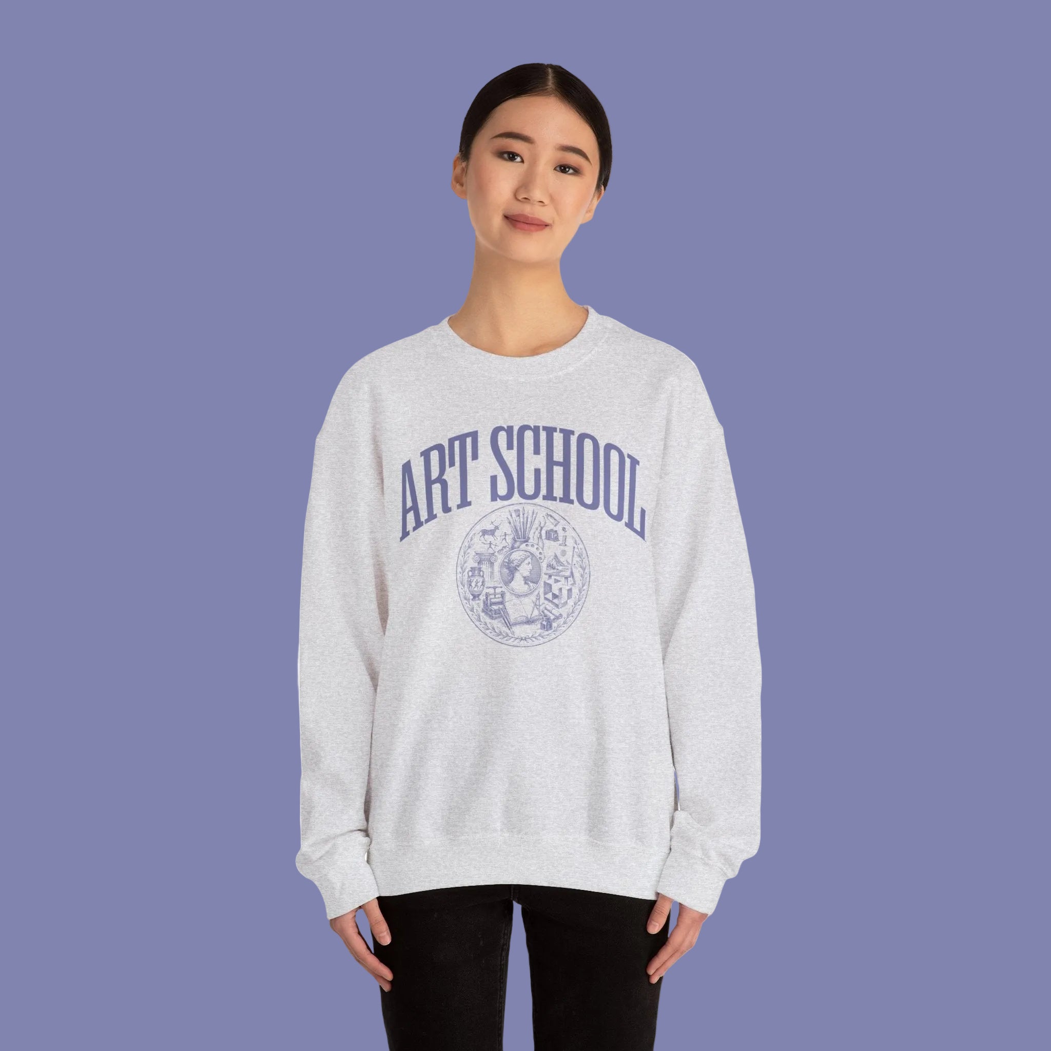 Person wearing a gray sweatshirt with 'AMOR' and a heart design on a white background