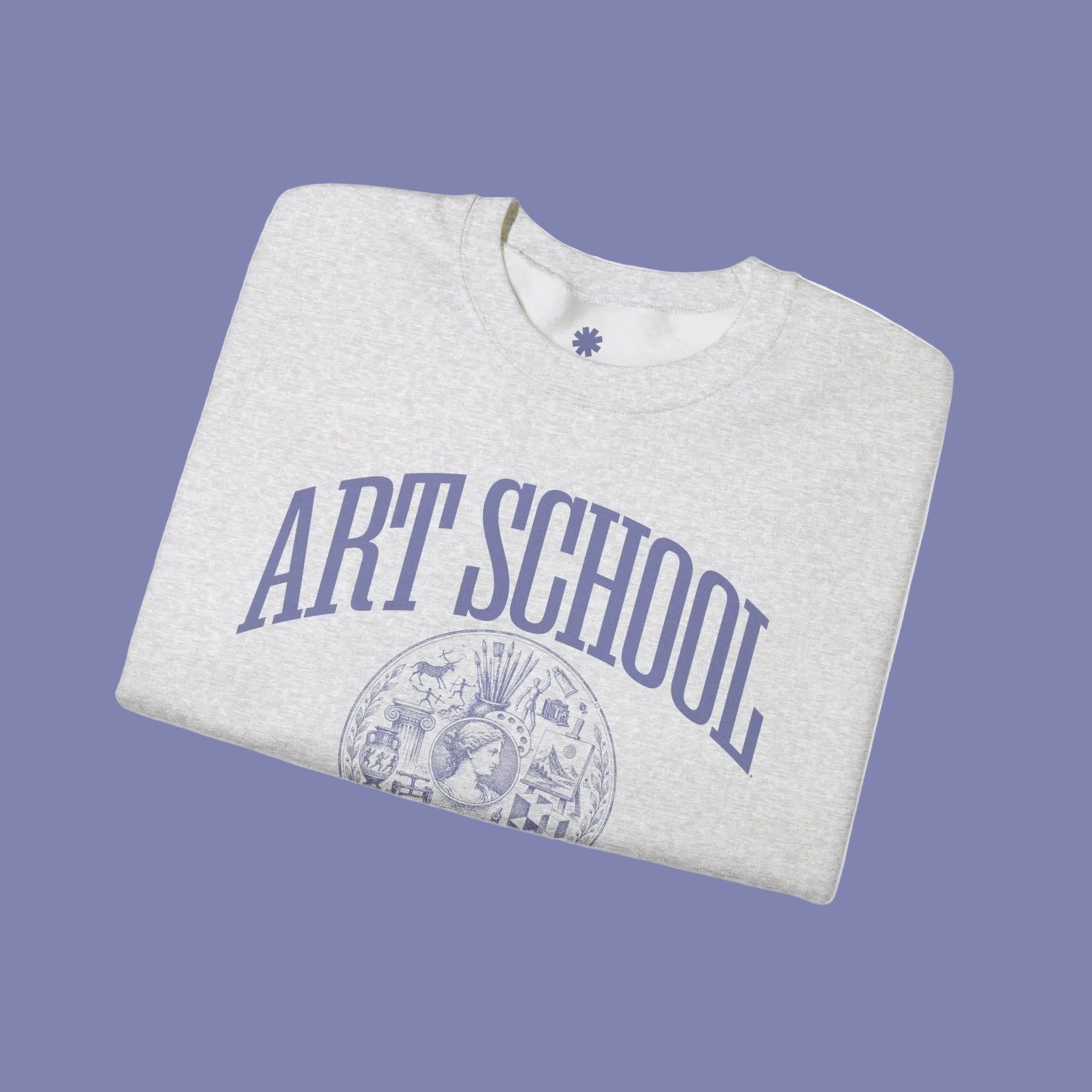 A folded light heather gray crewneck sweatshirt with 'ART SCHOOL' printed in a blue arch over a circular vintage-style illustration on the front, set against a plain white background.